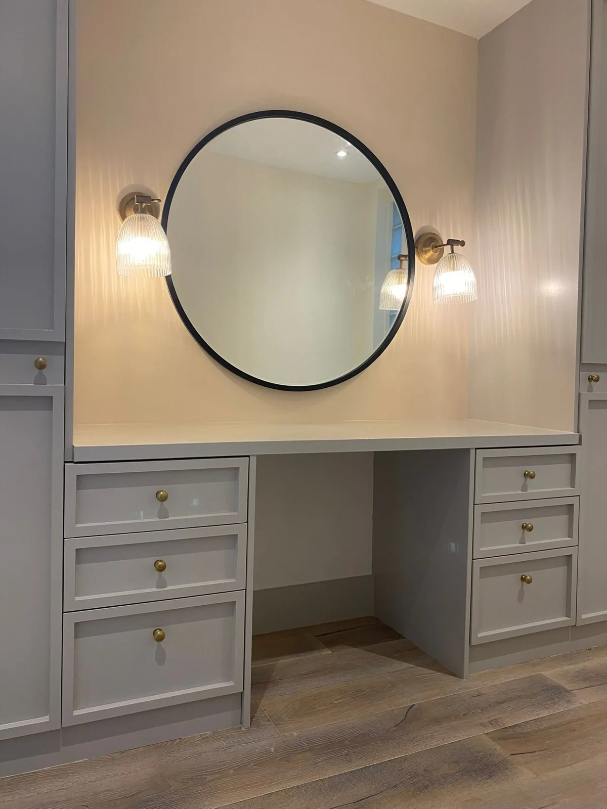 Bespoke built-in dressing table with drawers, mirror and brass hardware