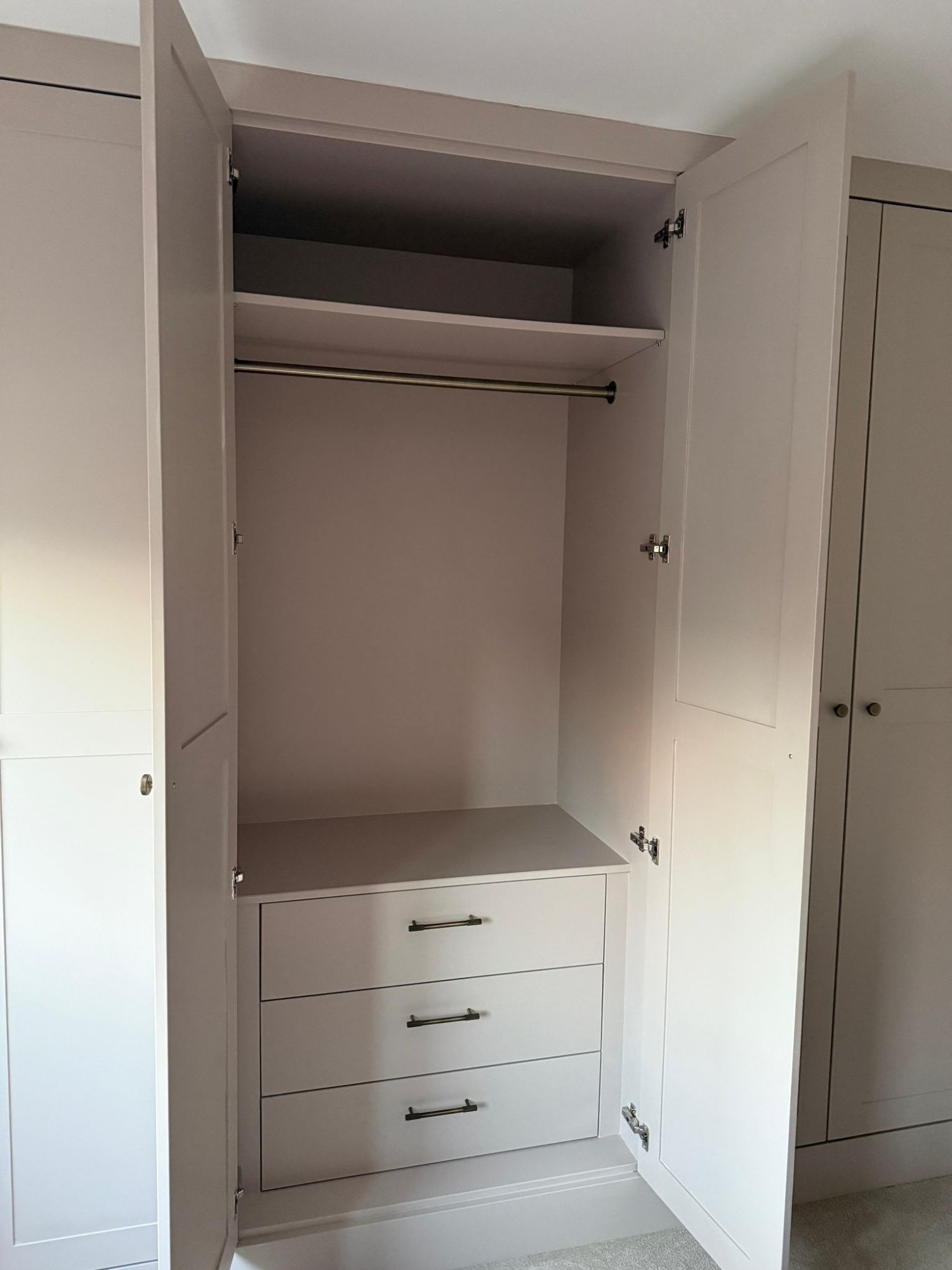 Fitted wardrobe interior with hanging rail and drawers