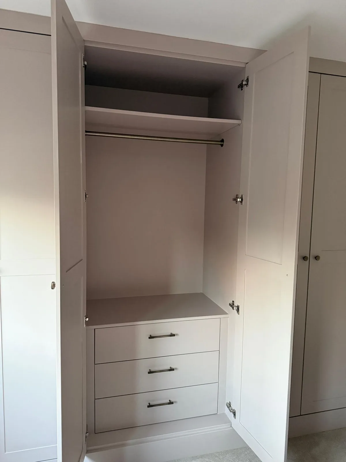 Fitted wardrobe interior with hanging rail and built-in drawers