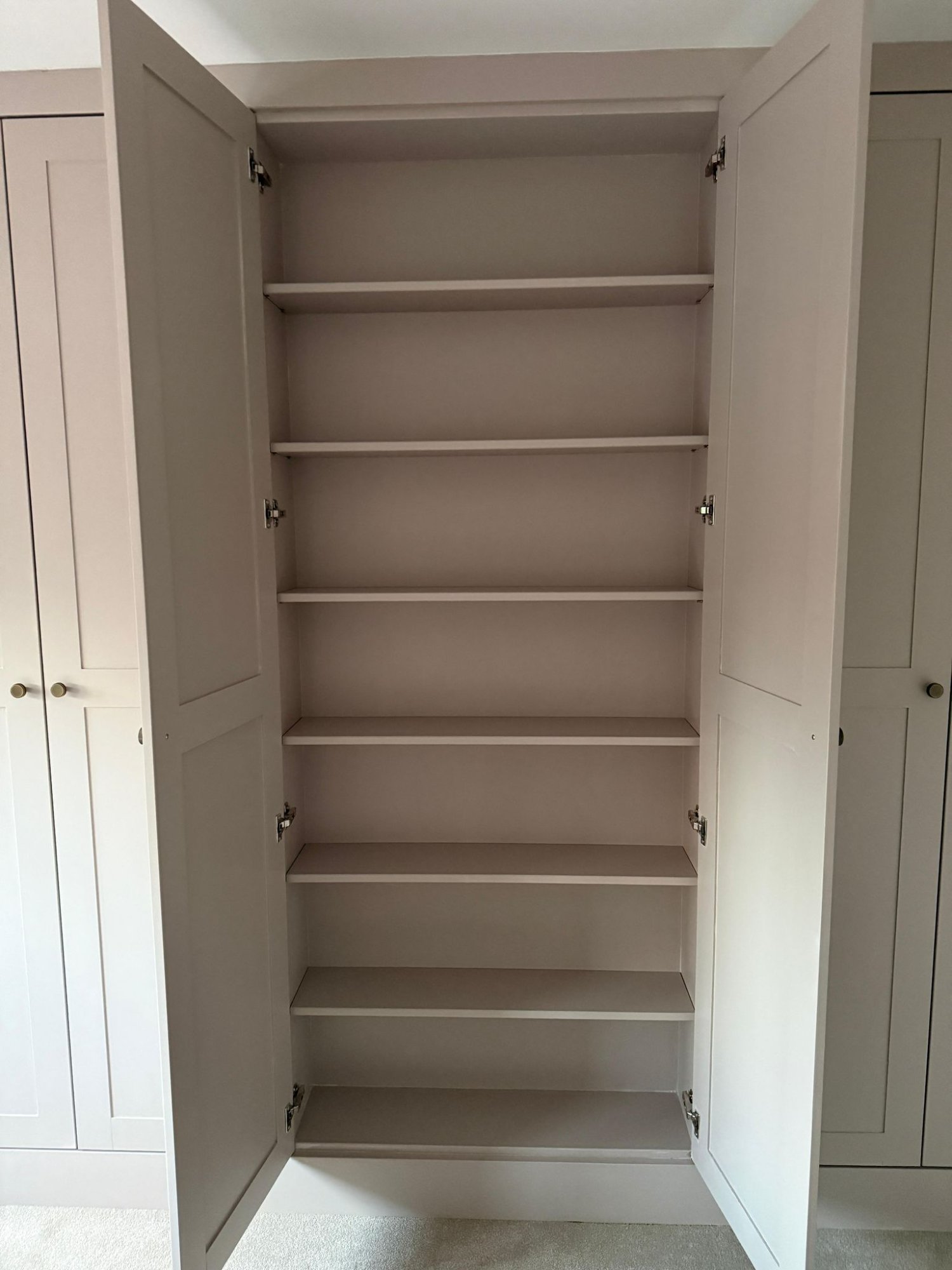 Custom wardrobe interior with adjustable shelving