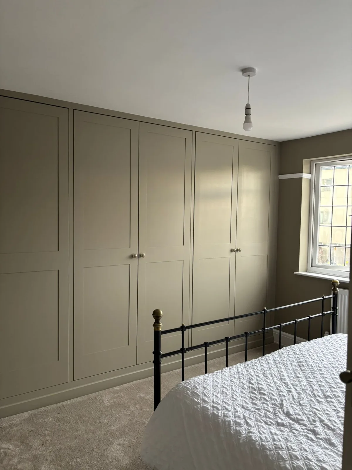 Bespoke fitted wardrobe with shaker doors in a Bristol bedroom